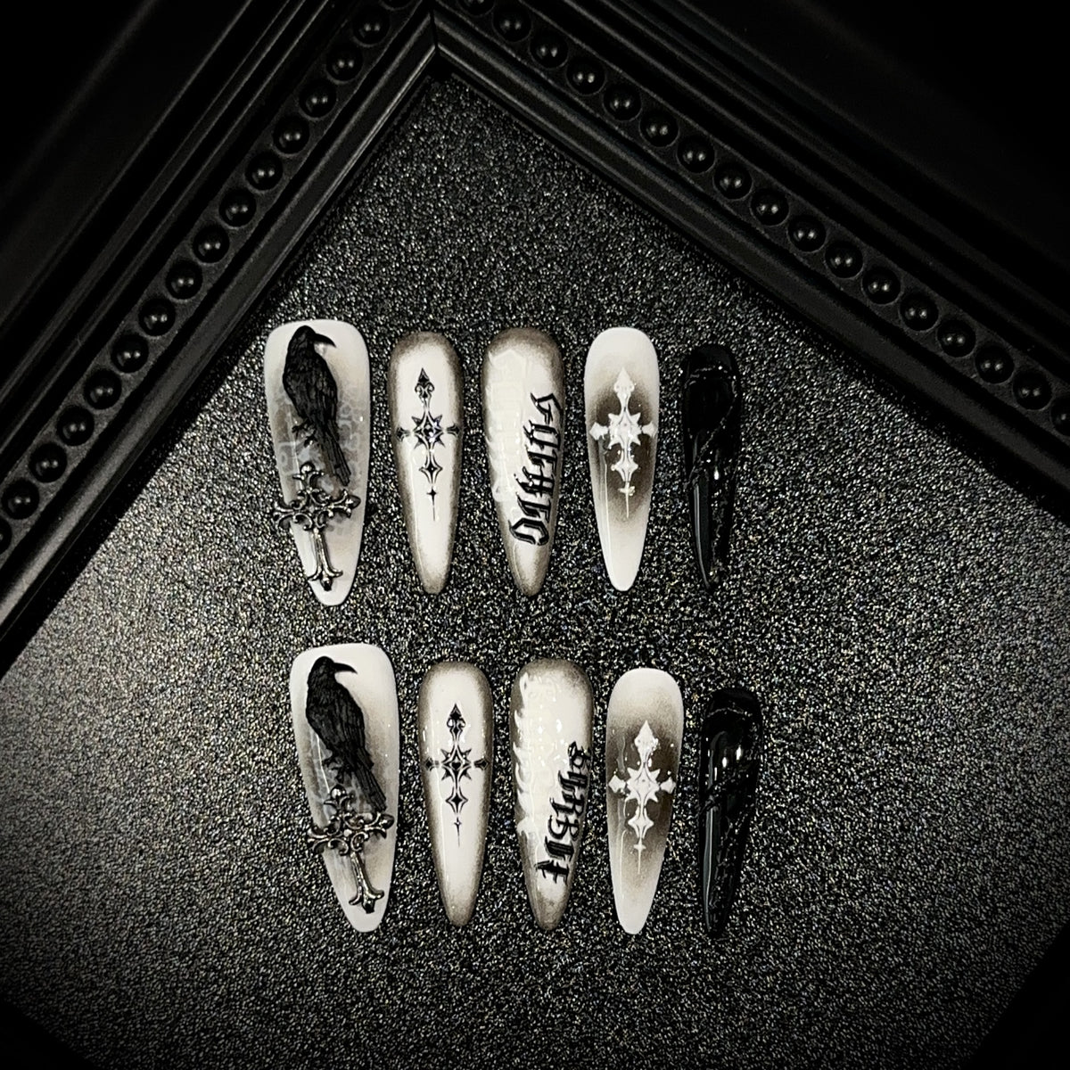 Black Raven Oath Long Stiletto Halloween press-on nails in almond — worn on both hands, full look