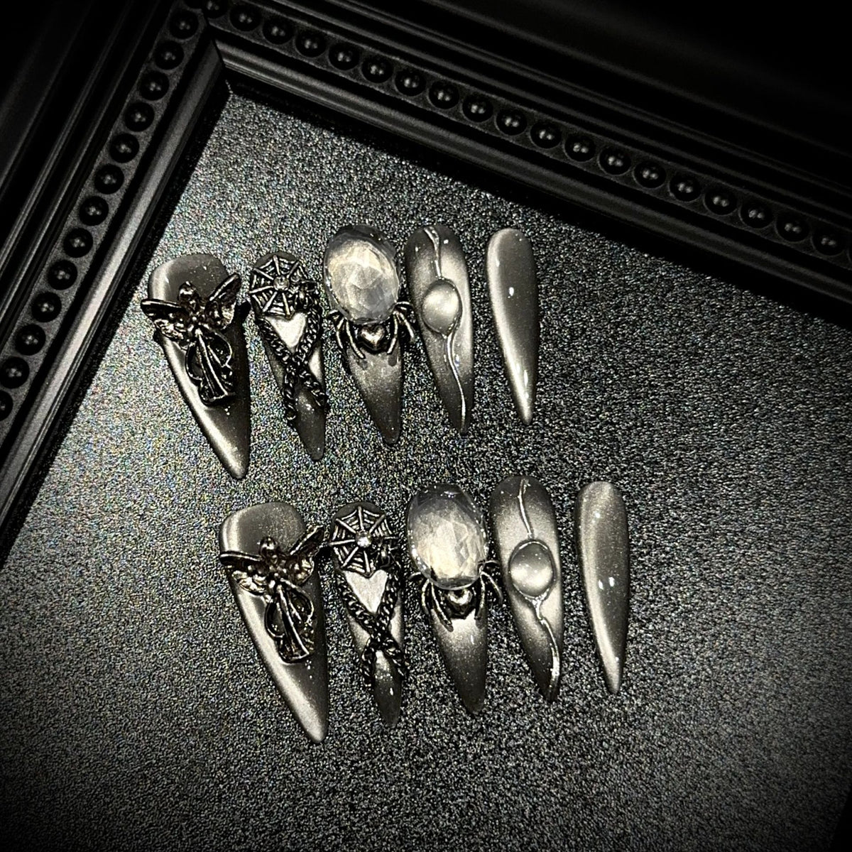 Divine Sacrifice Long Stiletto Cat Eye press-on nails in almond — worn on hand, close-up
