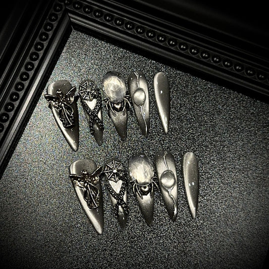 Divine Sacrifice Long Stiletto Cat Eye press-on nails in almond — worn on hand, close-up