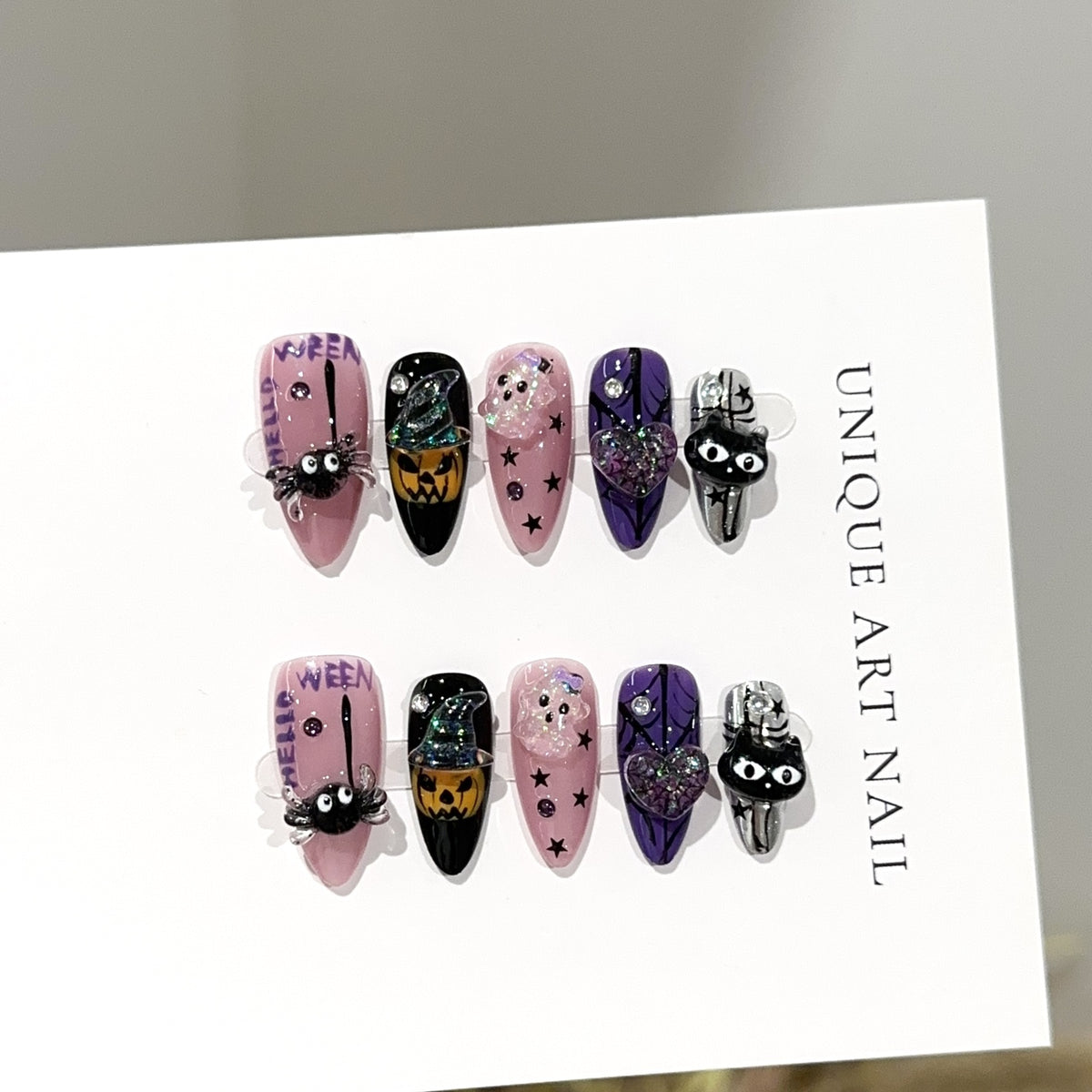 Halloween Carnival Almond press-on nails — worn on hand, close-up