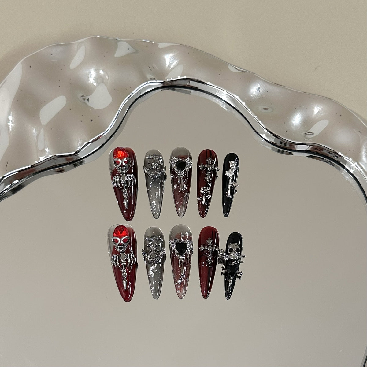 Blood Rose Long Stiletto press-on nails in almond — worn on both hands, full look