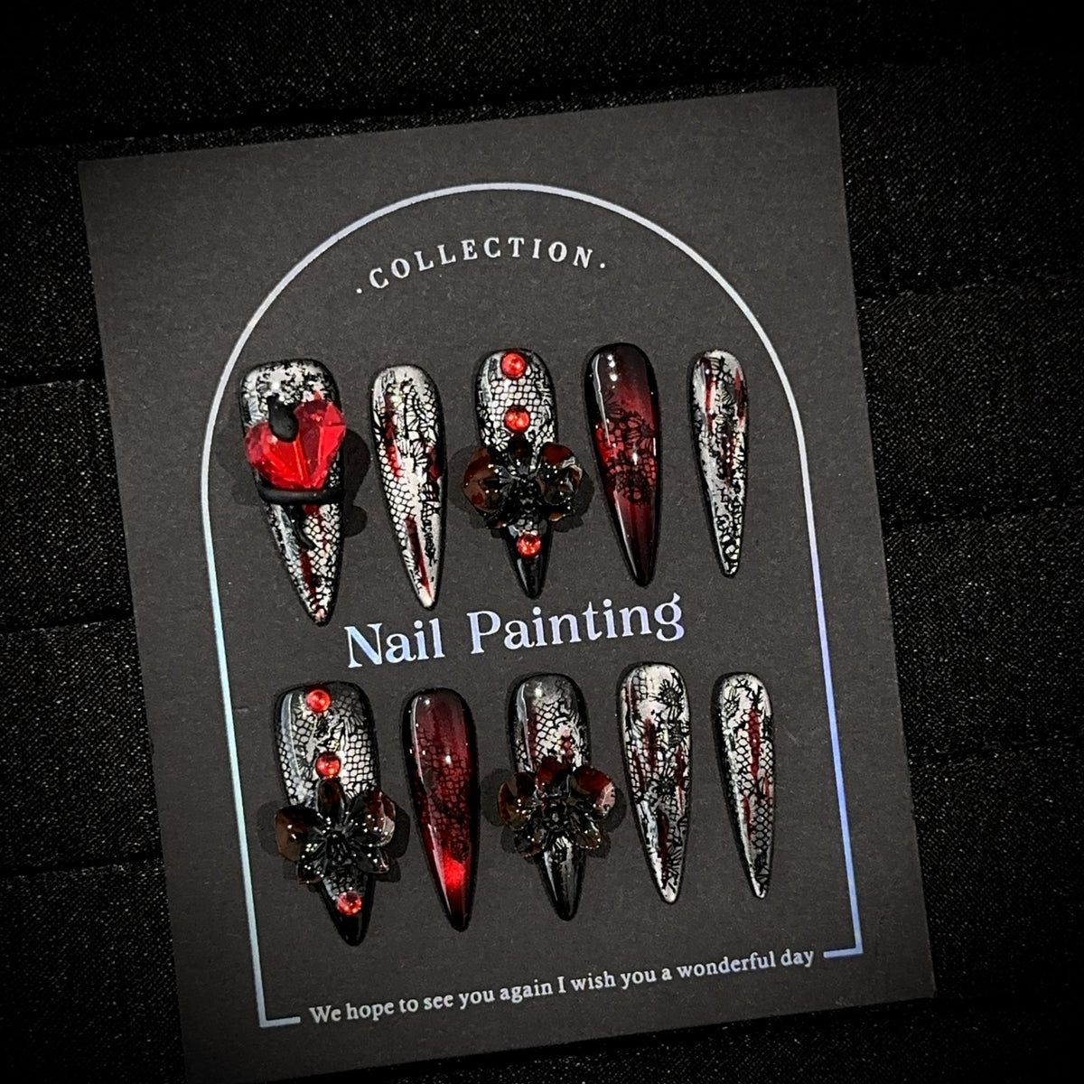 Blood Butterfly Long Stiletto Cat Eye press-on nails in almond — worn on both hands, full look