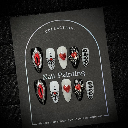 Hell's Eye Almond Halloween press-on nails — worn on hand, close-up