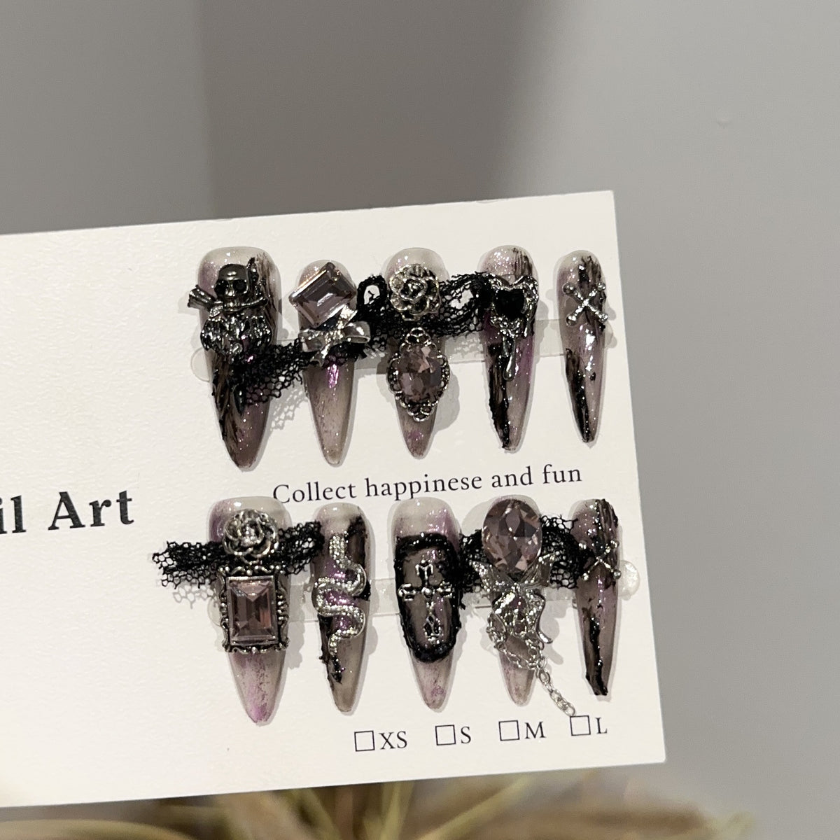 Magic Castle Long Stiletto Halloween press-on nails in almond — worn on hand, close-up