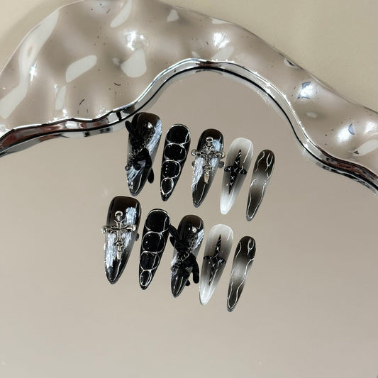 Misty Forest Long Stiletto press-on nails in almond — worn on hand, close-up