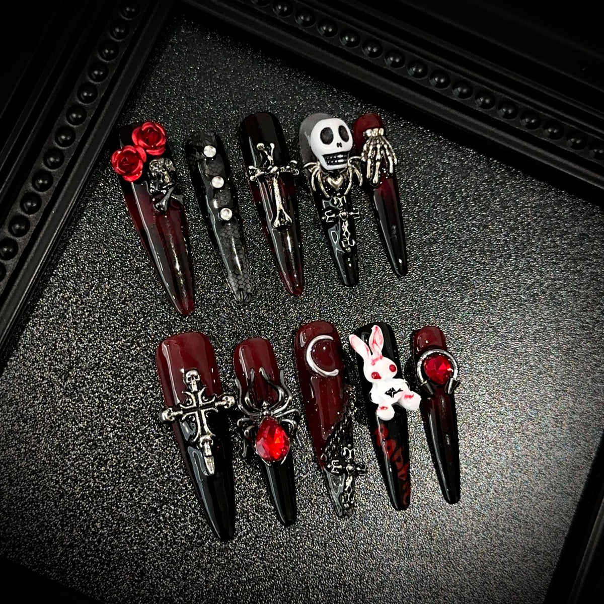 Blood Sacrifice Long Stiletto Halloween press-on nails in almond — worn on hand, close-up