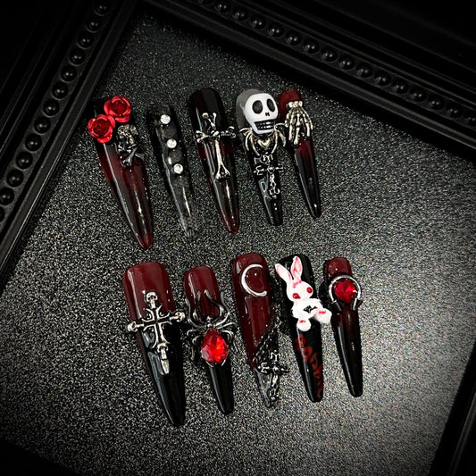 Blood Sacrifice Long Stiletto Halloween press-on nails in almond — worn on hand, close-up