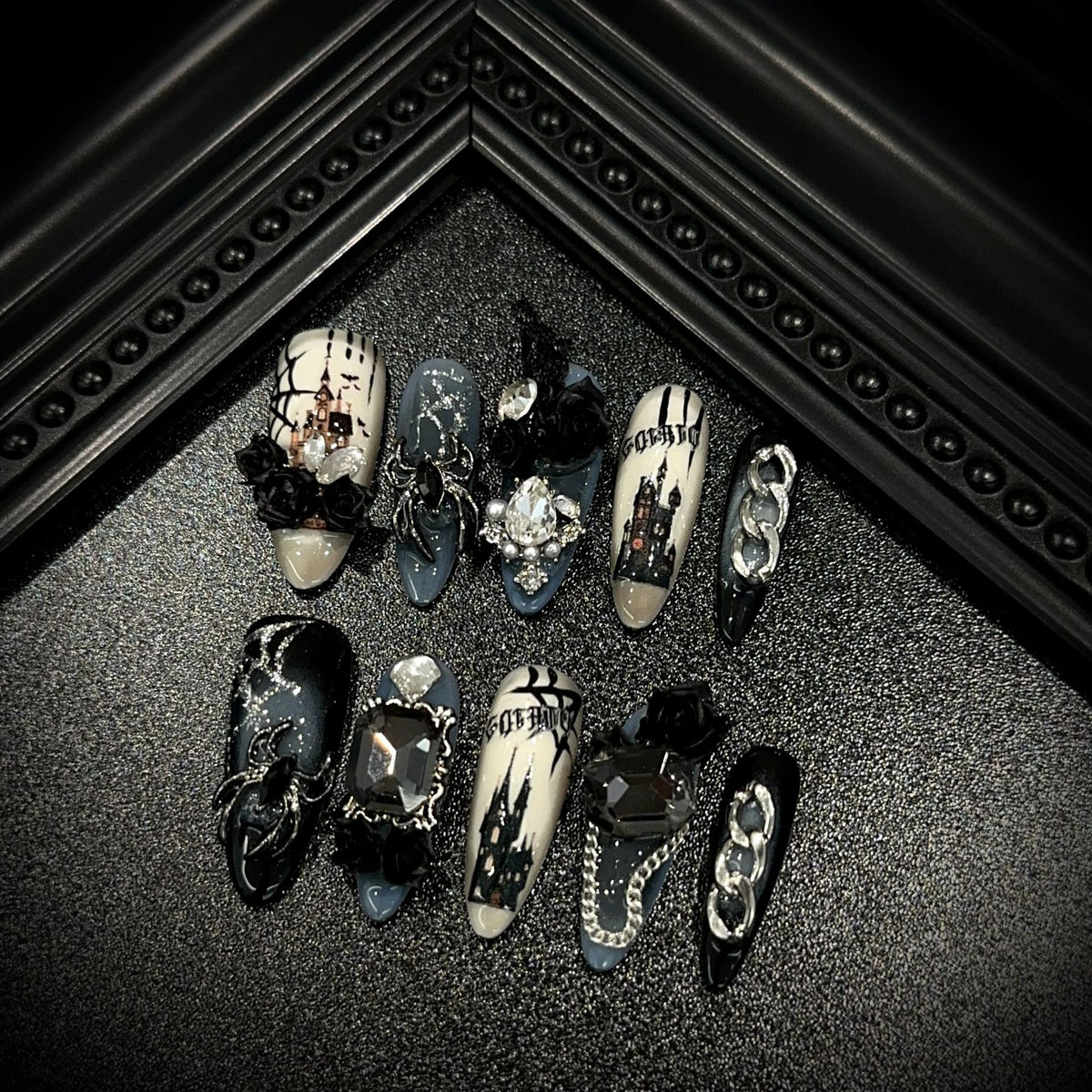 Dark Manor Long Oval Halloween press-on nails in almond — worn on both hands, full look