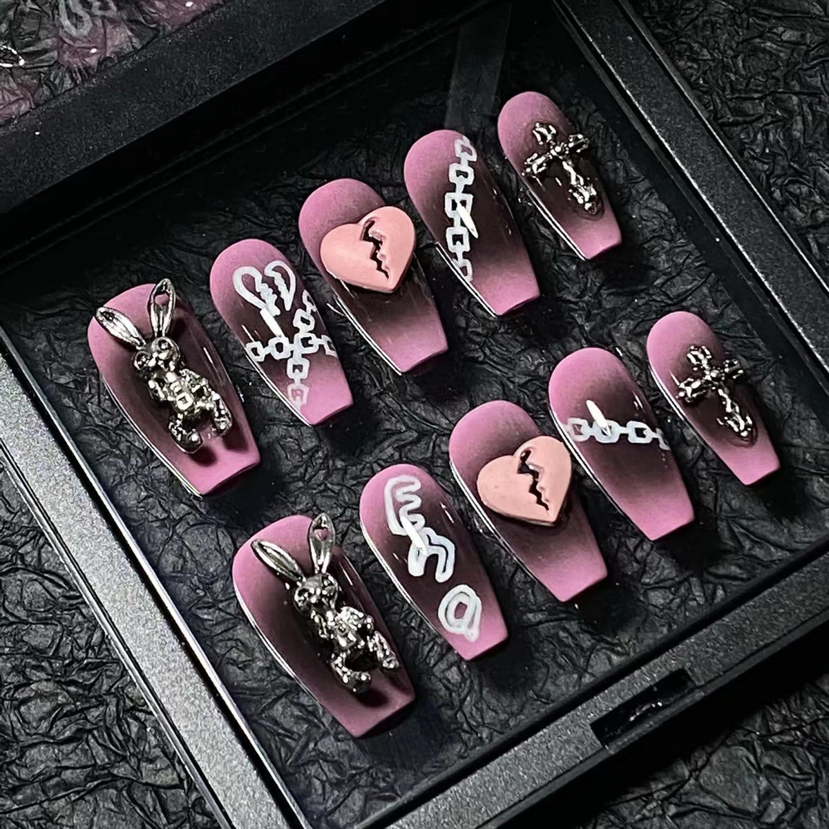 Heartbreak Bunny Medium Coffin press-on nails — worn on hand, close-up