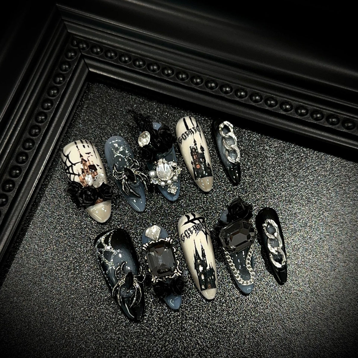 Dark Manor Long Oval Halloween press-on nails in almond — worn on hand, close-up