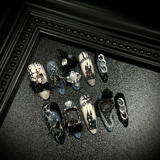 Dark Manor Long Oval Halloween press-on nails in almond — worn on hand, close-up