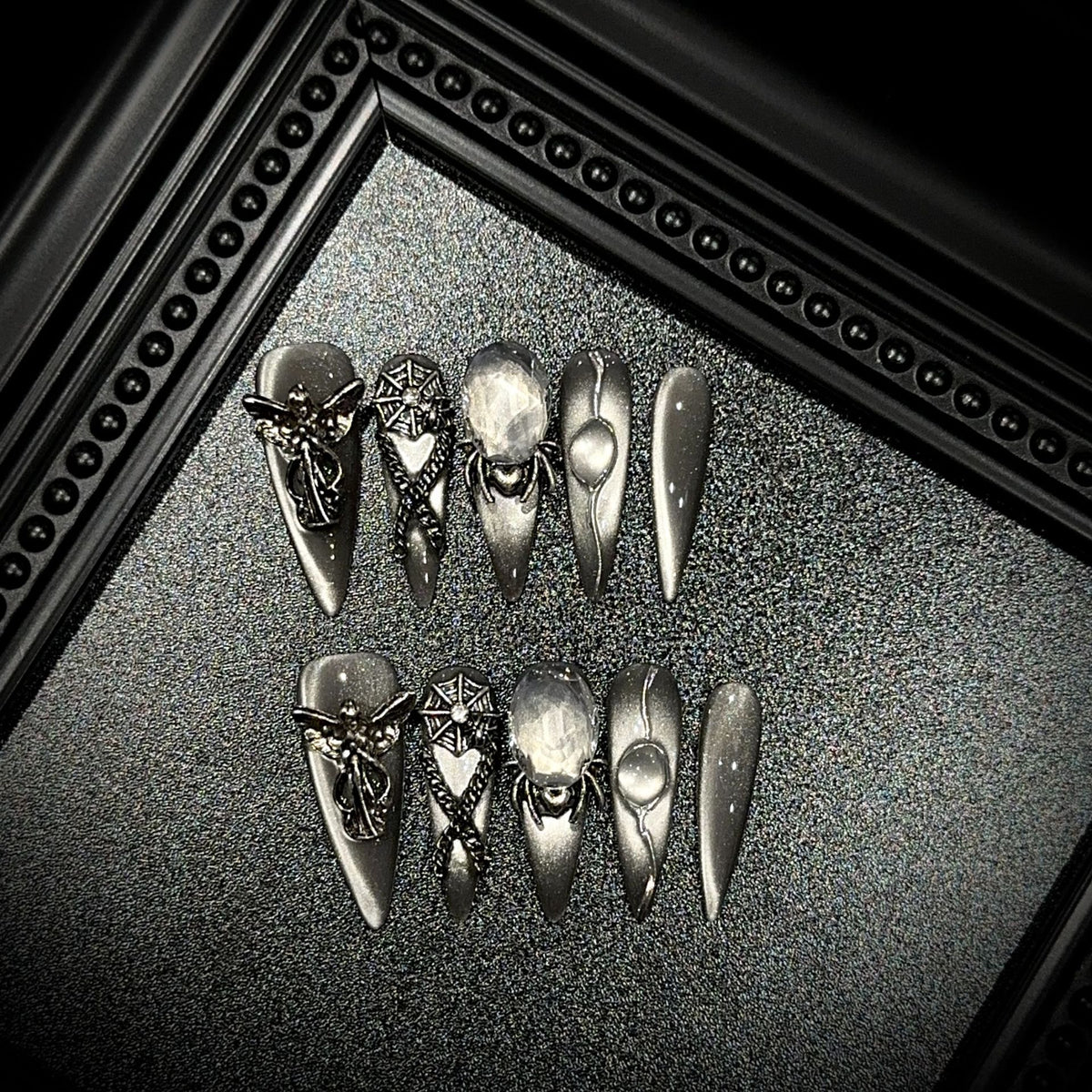 Divine Sacrifice Long Stiletto Cat Eye press-on nails in almond — worn on both hands, full look
