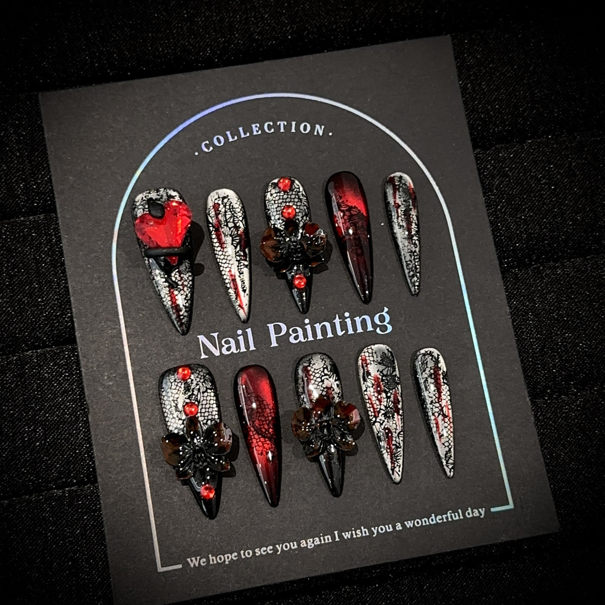 Blood Butterfly Long Stiletto Cat Eye press-on nails in almond — worn on hand, close-up