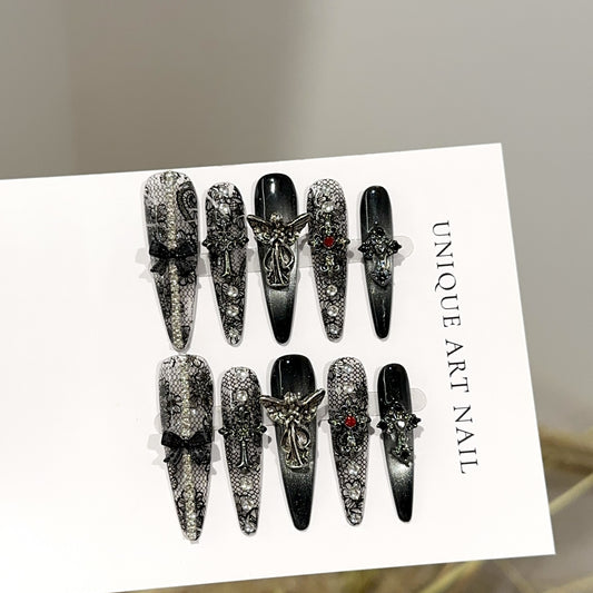 Fallen Angel Long Stiletto Gothic press-on nails in almond — worn on hand, close-up