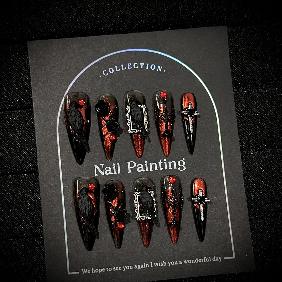 Raven Song Long Stiletto Halloween press-on nails in almond — worn on both hands, full look