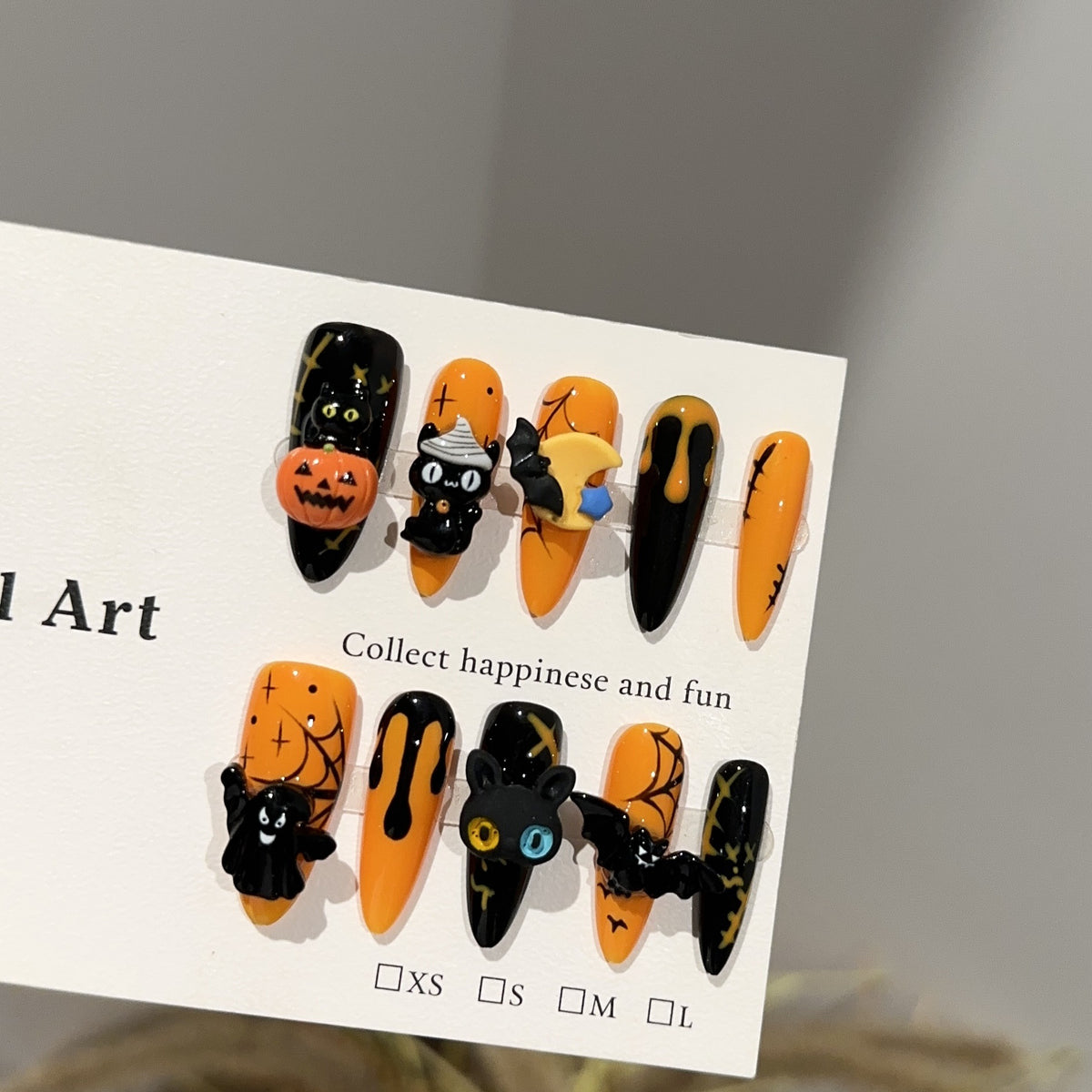 Spooky Pumpkin Long Oval Halloween press-on nails in almond — worn on both hands, full look