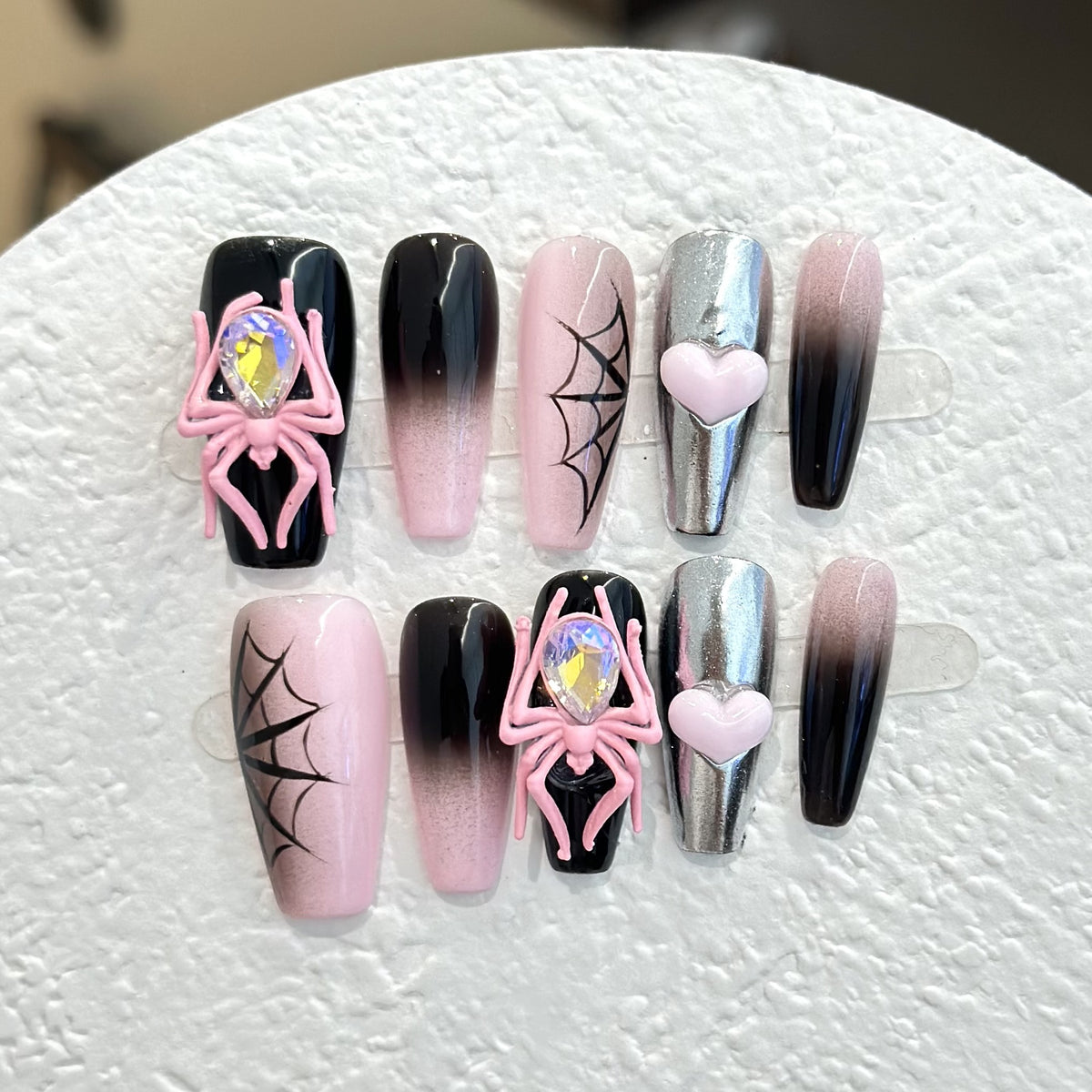 Black & Pink Spider press-on nails — full set in 12 sizes, laid out flat