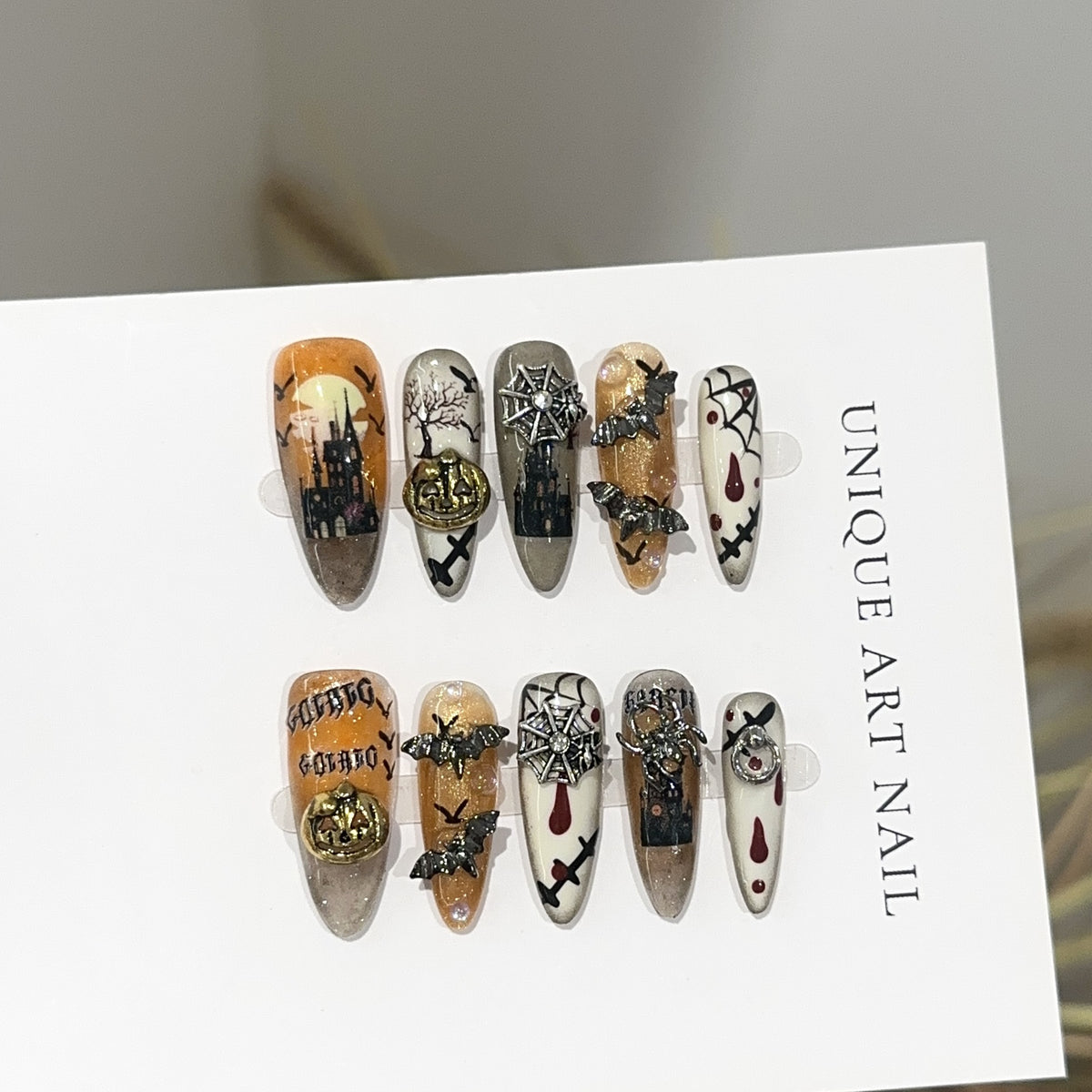 Bat Attack Long Oval Halloween press-on nails in almond — worn on hand, close-up