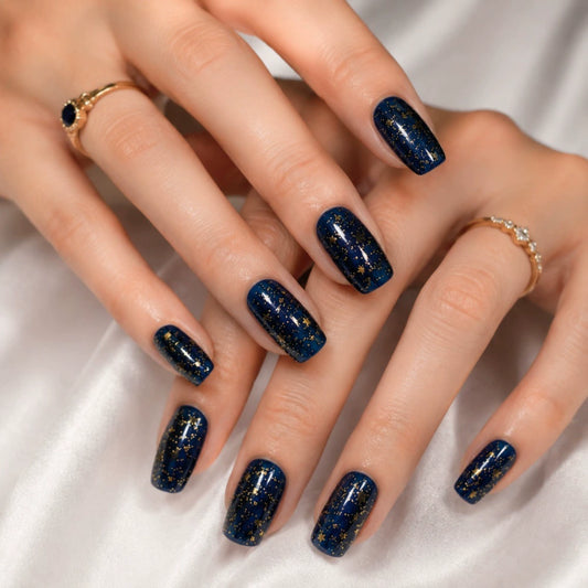 Blue press-on nails in almond — worn on hand, close-up
